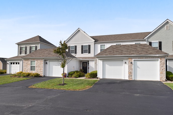Hilliard Summit 2-story apartment community adorned with garages, lush grass, and mature trees.