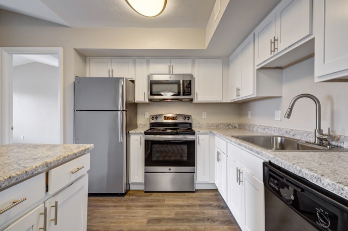 The contemporary kitchen features sleek design and modern amenities for residents' convenience.