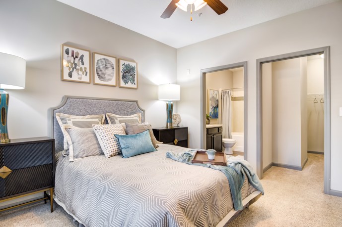 At Waterstone at Big Creek in Alpharetta, GA, a cozy carpeted one-bedroom apartment complete with an en-suite bathroom for added convenience.