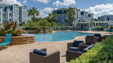 The outdoor lounge at The Enclave at Tranquility Lake with seating areas and a fireplace for residents to enjoy.