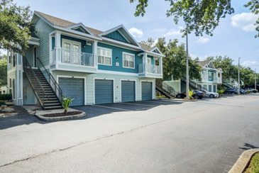Apartment home exterior at The Enclave at Tranquility Lake with private garages.