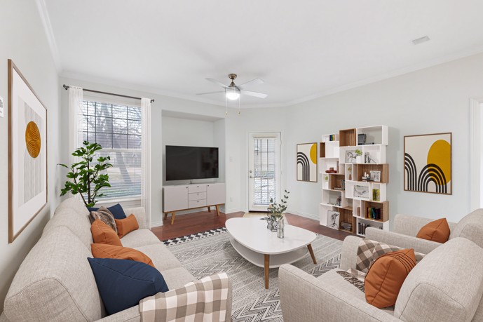 Inviting living room, featuring a large window, ceiling fan, hardwood-style flooring, and convenient outdoor access.