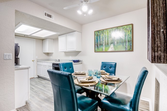 A dining table located in the dining room adjacent to the kitchen at Windrush apartments, providing residents with a convenient and comfortable space to enjoy meals and entertain guests.