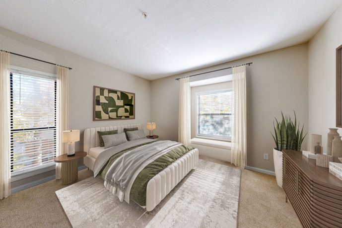 A cozy living room with a brown couch, green chair, and wall mounted television.
