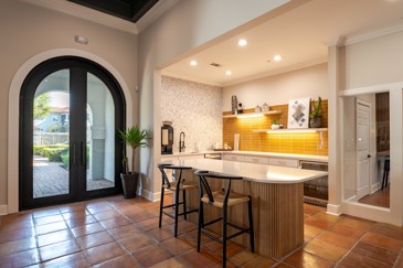 The clubhouse kitchen at The Pointe at Vista Ridge is situated near the entryway, offering convenience and accessibility for residents and guests.