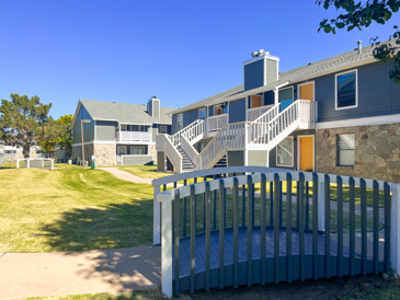 The exterior of the Windrush apartment building with landscaping. 