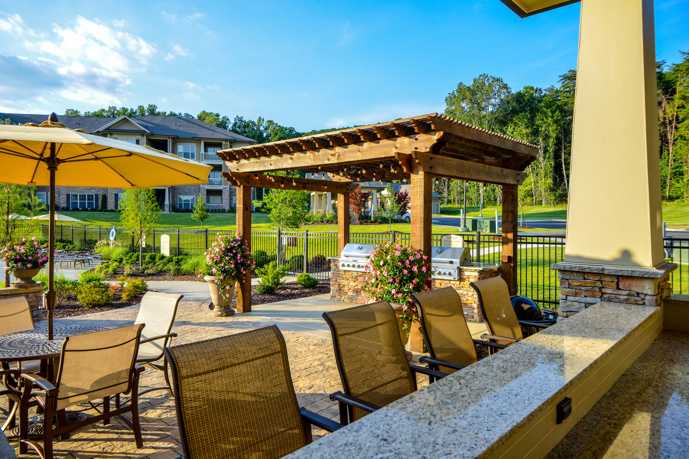 Poolside lounge and grilling area, surrounded by rolling hills and nature trails