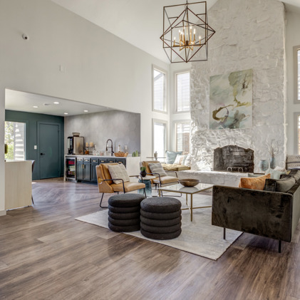 The Invitational features a community clubhouse with a cozy seating area next to a fireplace.