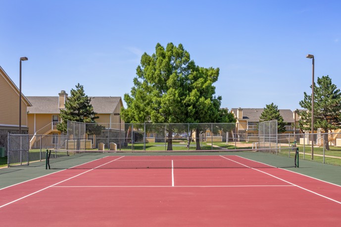 A tennis court located near the Windrush apartments, providing residents with a fun and convenient space to stay active and enjoy the outdoors.