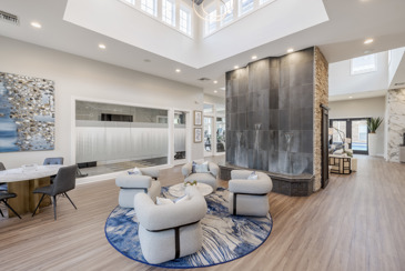 The clubhouse at The Chelsea with assorted seating, water feature, and offices.