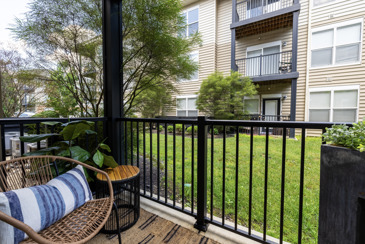 A patio at The Chelsea with a chair and a side table. 