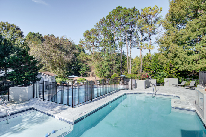 A fireside lounge with lawn chairs surrounding the brick firepit.