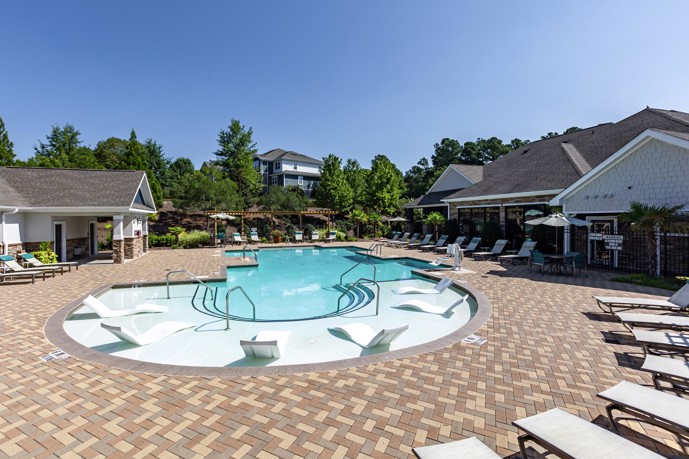 The resort-style pool at Waterstone at Brier Creek apartments, situated outside the clubhouse, provides a luxurious outdoor retreat for residents.