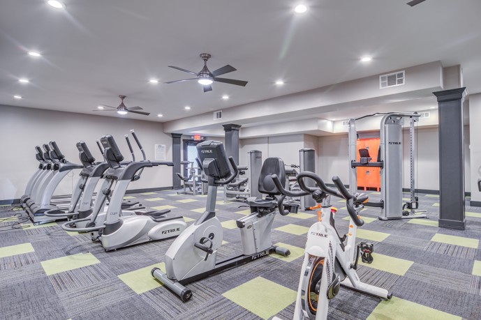Fitness center at the 1800 at Barrett Lakes: A modern gym facility with treadmills