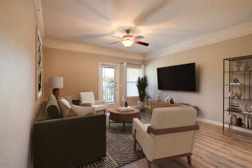 Empty apartment living room with vinyl plank flooring, a ceiling fan, and door and window